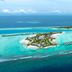 Aerial view of Hard Rock Hotel Maldives in Malé, showing a turquoise lagoon and overwater villas.