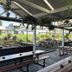 The Oaks Hotel Motel in Wollongong outdoor covered dining area with picnic tables and greenery