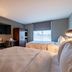 Four Points by Sheraton Brunswick guest room with two beds, desk, TV and window view