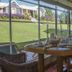 Los Ponchos Hotel in El Calafate dining room with large windows overlooking a green hillside