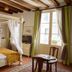 La Demeure Saint-Ours in Loches: four-poster bed, exposed beams, and window seating area