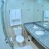 Citi Hotel Residence Caruaru bathroom with granite vanity, large mirror, and toilet in Caruaru