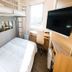 Super Hotel Gotsu-Ekimae compact single room with loft bed, desk, and wall-mounted TV in Gōtsu