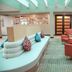 Holiday Inn Metairie New Orleans lobby with curved seating area and coral lounge chairs