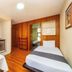 Capital O Hotel Suites Marne, Mexico City room with twin beds, kitchenette and wood-paneled walls