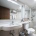 Oriens Hotel & Residences Myeongdong Seoul bathroom with sink, toilet and glass shower