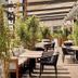Hyatt Regency London Stratford outdoor terrace with tables, chairs, and potted plants in London