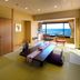 Inn Nakaya in Kamogawa guest room with tatami area and ocean view through large window