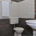 Hotel M City, Amritsar bathroom with toilet, sink, towel, and wall-mounted bucket
