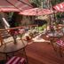 Elliott House Boutique Inn in Shaver Lake with a wooden deck, red umbrellas, and forest views