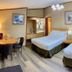 Sunwapta Falls Rocky Mountain Lodge in Jasper guest room with two beds and dining area