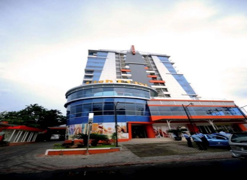 High Point Surabaya hotel exterior with a curved glass facade and tall modern tower in Surabaya