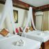 Angkor Pearl Hotel in Siem Reap guest room with two canopy beds and white curtains