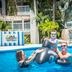 Margaritaville Beach Resort Grand Cayman pool scene with family on inflatable whale in George Town