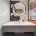 ibis Beijing Dacheng Road bathroom with sink, round mirror and modern vanity in Beijing