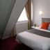 Hotel Le Canada in Hermanville-sur-Mer guest room with double bed, window light and wall lamps