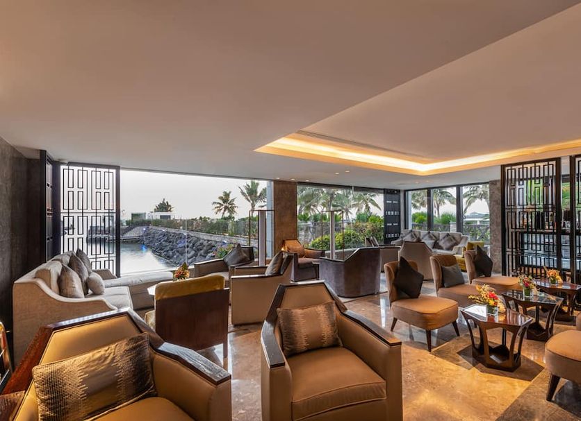 Narcissus Obhur Resort & Spa in Jeddah lounge with floor-to-ceiling windows and outdoor pool view