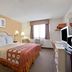 Super 8 by Wyndham Clearwater/St. Petersburg Airport room with king bed, desk, TV and window air conditioner