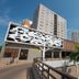 Hotel Gran Odara in Cuiabá, exterior with mural facade, tower, palm trees and driveway
