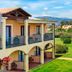 Hotel Santa Gilla in Capoterra with balconies overlooking a lush garden and palm tree