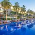 Al Zorah Beach Resort in Ajman with palm-lined infinity pool and lounge chairs