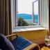 Bryn Melyn Apartments in Barmouth room with open window and sea and hill views