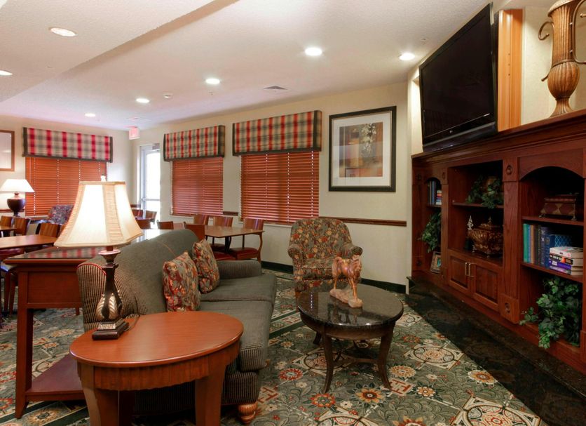 Residence Inn by Marriott Oklahoma City South lounge with sofas, TV, lamp and patterned carpet