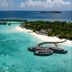 Milaidhoo Maldives, Kamadhoo: overwater villas and a curved deck above turquoise lagoon