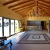 4 Epoches Hotel Alonissos lobby with vaulted wood ceiling, tiled floor, and glass walls in Steni Vala