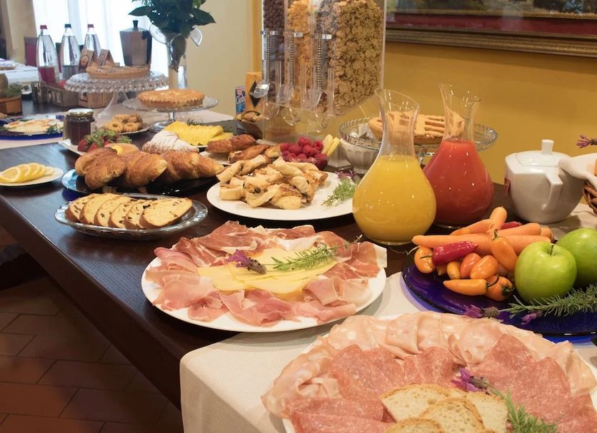 Breakfast buffet spread at Residence Mugello Resort in Scarperia e San Piero with fruit, pastries and cold cuts