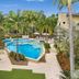 Montpellier Boutique Resort in Noosaville with a tropical pool, palm trees and sun loungers