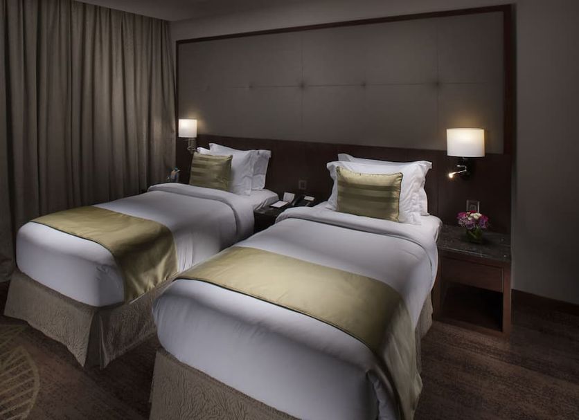 Ramee Rose Hotel in Manama twin room with two beds, bedside lamps, and neutral modern decor