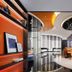 Hampton By Hilton Beijing Wangjing lobby with glossy floor, curved ceiling, orange-lit shelves and seating