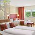Pfalzhotel Asselheim in Gruenstadt: colorful twin guest room with countryside view and two beds