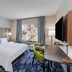 Fairfield by Marriott Inn & Suites Aberdeen, SD guest room with king bed, desk, chair and window view in Aberdeen