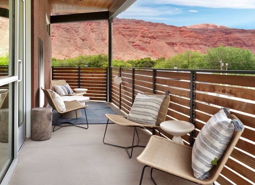 Gravity Haus Moab patio with lounge chairs and desert red rock mountain views in Moab