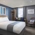 Travelodge London Twickenham guest room with double bed, desk, chair and city view
