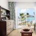 Coconut Bay Resort in Vieux Fort with balcony view of pool and palm trees from a guest room