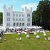 Grand Hotel Heiligendamm in Bad Doberan with a white castle-style façade and outdoor terrace event on the lawn.