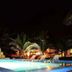 La Casa de Sebas, Máncora: illuminated outdoor pool with lounge chairs and palm trees at night