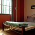Tonkong Guesthouse & Restaurant in Chiang Khan room with bed by a window and framed wall art