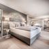 Steigenberger Hotel Treudelberg Hamburg guest room with king bed, modern bath area and bright seating nook