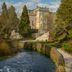 Crossbasket Castle, Glasgow, beside a river with stone steps and landscaped gardens