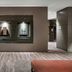 AC Hotels by Marriott Bologna lobby with modern seating, glass display niche, and wood-look flooring