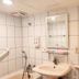 Sin Fu Business Hotel, Taichung City bathroom with sink, mirror, bathtub, towel shelf and grab bar