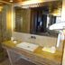 Hotel Airport Centre Point Nagpur bathroom with glass shower, stone vanity, and large mirror