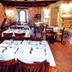 Villaggio Della Salute Più in Monterenzio: rustic stone dining room with set tables and wooden chairs