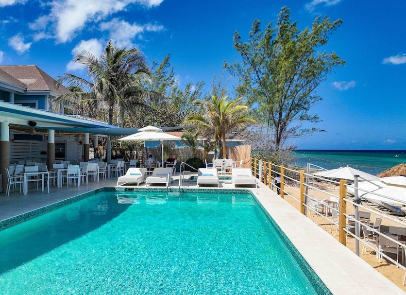 Cobalt Coast Resort in West Bay: beachfront pool deck with ocean views and lounge chairs