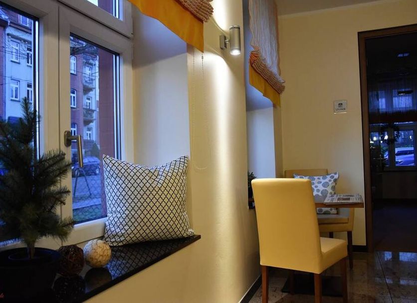 Hotel Brühlerhöhe in Erfurt interior with window seating and a small table by a lit wall