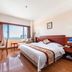 Zhiyuanlou Hotel Qingdao guest room with king bed and ocean view window